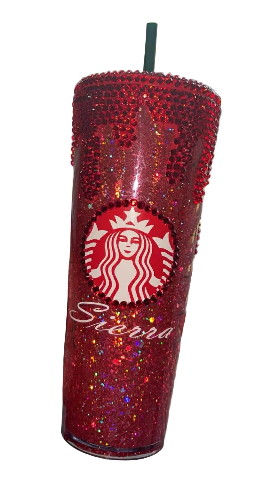 Red glittery Starbucks tumbler held in front of a window with blinds.
